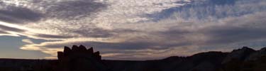 silhouetted stegosaurus at sunset